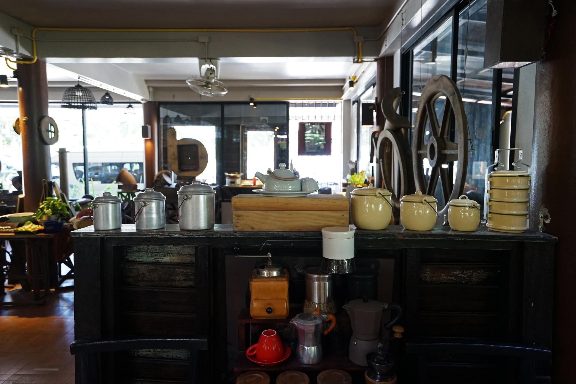 small cafe kitchen with stove and pans