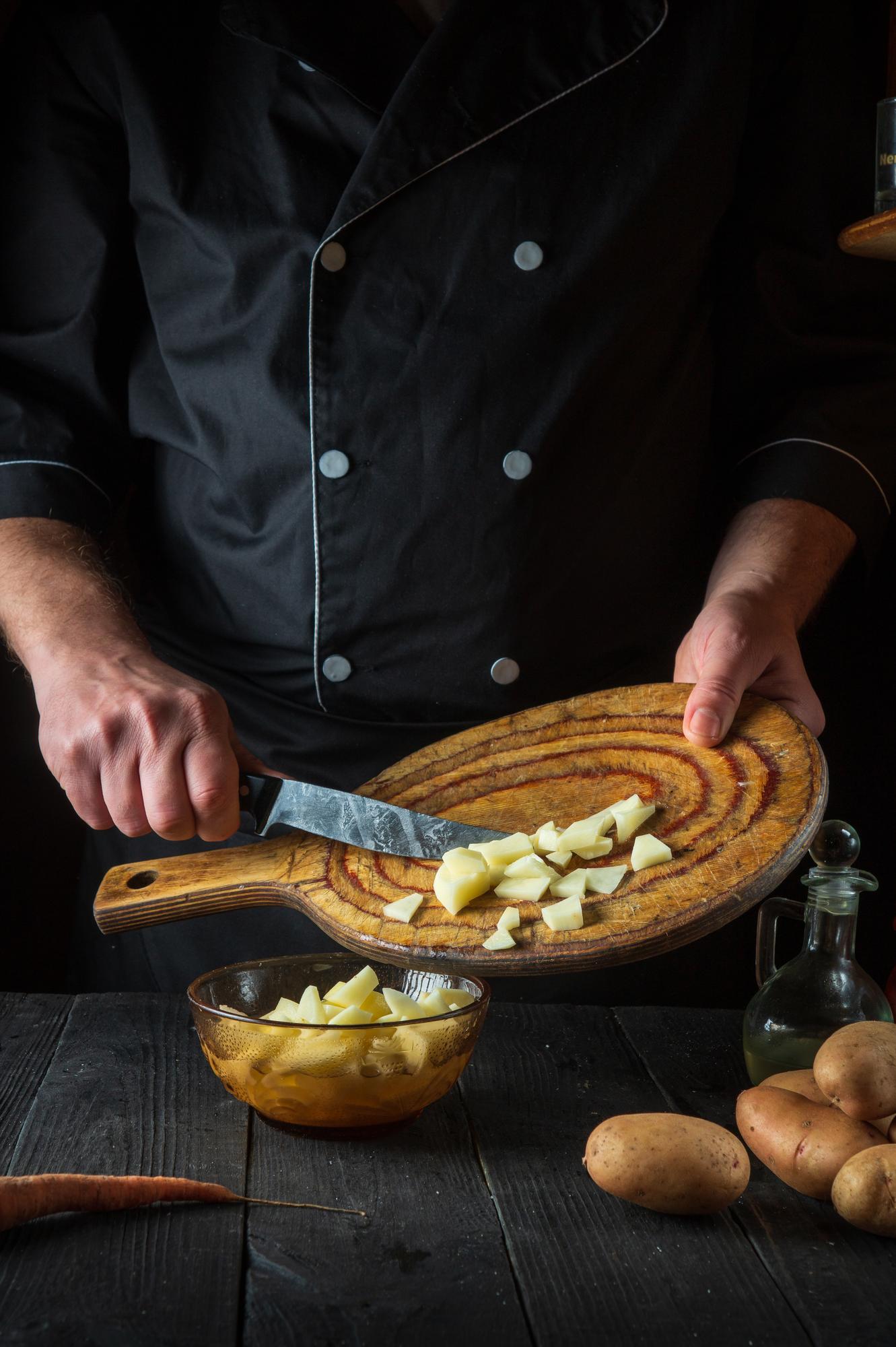 chef preparing rustic dish in warm kitchen